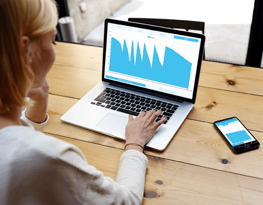 A woman analyzing her home heating oil consumption with Smart Oil Gauge App